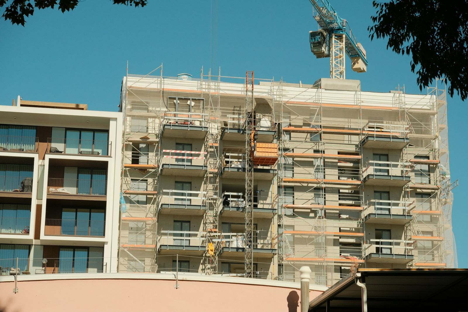 Ein Wohnhaus im Bau mit Gerüst und Kran